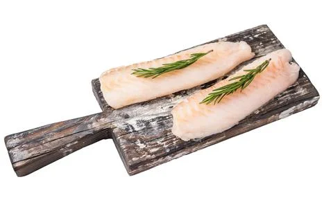 Raw cod Loin, white fish fillets without skin on wooden board isolated on w.. Stock Photos