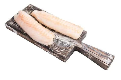 Raw cod Loin, white fish fillets without skin on wooden board isolated on w.. Stock Photos