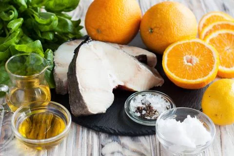 Raw cod, oranges, ingredients for cooking Stock Photos