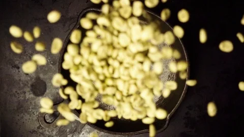 Raw coffee beans in a frying pan slow mo Stock Footage 73417383