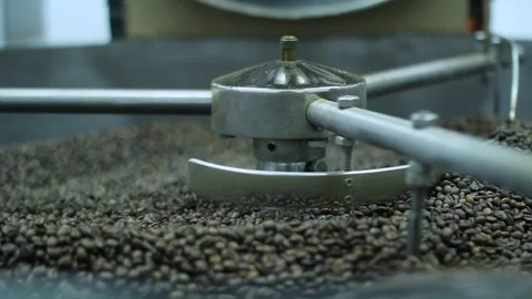 Raw coffee beans, roasting on a large toaster machine Stock Footage 100143869