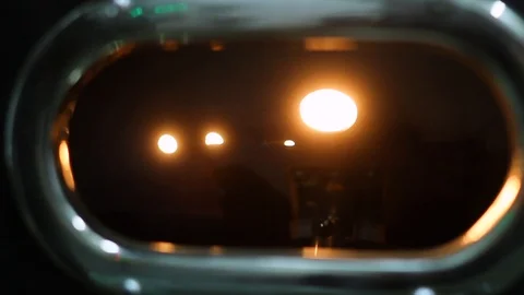 Raw coffee beans rotating behind checking window in roast machine Stock Footage 100143806