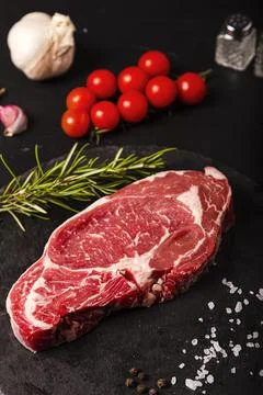 Raw colored beef meat on a slate ready for grilling Stock Photos