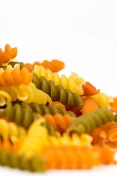 Raw colored macaroni isolated over white background Stock Photos