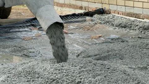 Raw concrete solution is poured through a tube of cement truck close-up Stock Footage 287448578