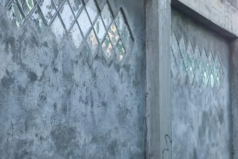 Raw Concrete Wall with Diamond Pattern Glass Blocks Stock Photos