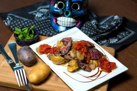Raw cooked steak served with potato and tomato sauce Stock Photos