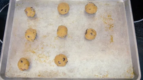 Raw Cookie Dough Balls Appear in Stop Motion on Metal Baking Sheet - 4K Stock Footage 101915359