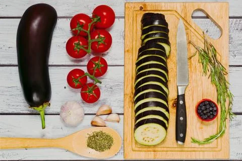 Raw cooking ingredients for preparing grilled eggplants Stock Photos