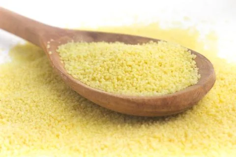 Raw Couscous in a spoon Stock Photos