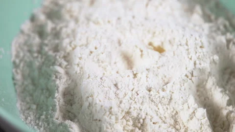 Raw cracked eggs being poured onto a heap of flour Stock Footage 162482910