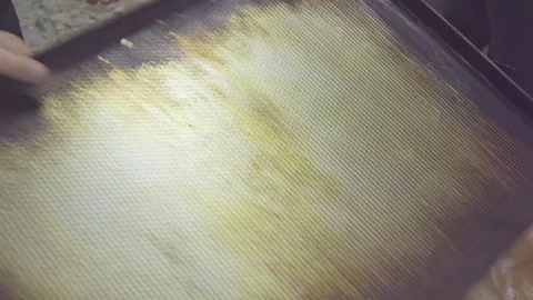 Raw croissant on tray before baking HD video. Baker at bakery prepares pastry Stock Footage 74727917