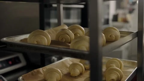 The raw croissants  lies on baking sheets to allow the dough to rise. Stock Footage 267015359