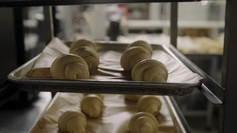 The raw croissants  lies on baking sheets to allow the dough to rise. Stock Footage 267015431