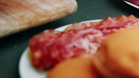Raw cured meat and tomato slices ready for cooking, 4K Stock Footage 341117141