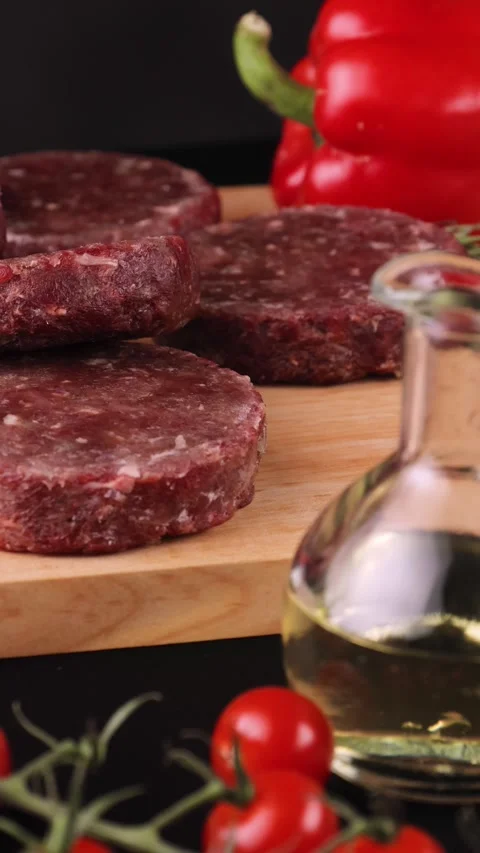 Raw cutlets fall on a wooden board farm products Stock Footage 262875703