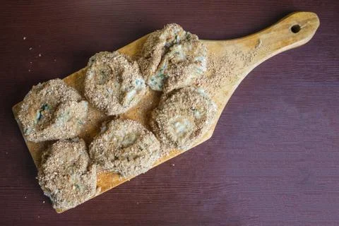 Raw cutlets on the kitchen board. Stock Photos