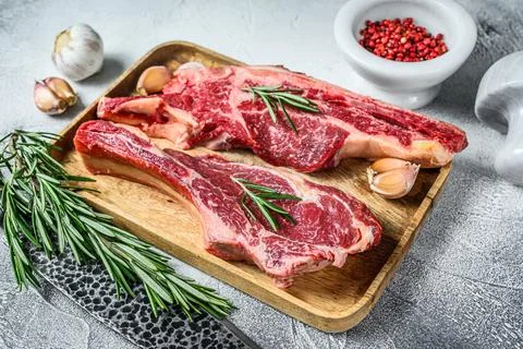 Raw cuts of beef marble meat on the bone. White background. Top view Stock Photos
