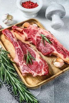 Raw cuts of beef marble meat on the bone. White background. Top view Stock Photos