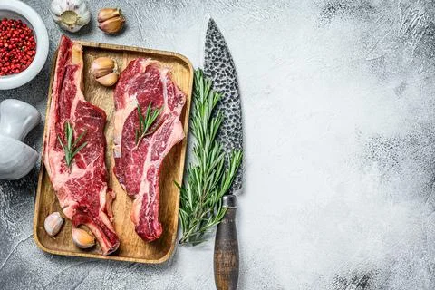 Raw cuts of beef marble meat on the bone. White background. Top view. Copy space Stock Photos