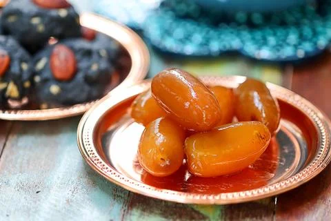 Raw dates fruit and cookie charcoal on wooden table. Ramadan and Middle Easte Stock Photos