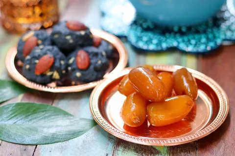 Raw dates fruit and cookie charcoal on wooden table. Ramadan and Middle Easte Stock Photos