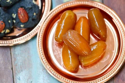 Raw dates fruit and cookie charcoal on wooden table. Ramadan and Middle Easte Stock Photos