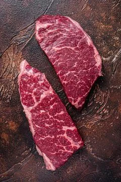 Raw Denver steak Marble beef meat. Dark background. Top view Stock Photos