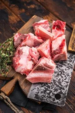 Raw diced Beef meat with bones for stew or goulash on wooden board. wooden .. Stock Photos