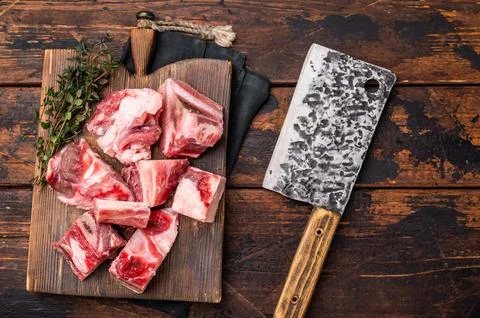 Raw diced Beef meat with bones for stew or goulash on wooden board. wooden .. Stock Photos