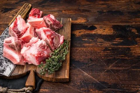 Raw diced Beef meat with bones for stew or goulash on wooden board. wooden .. Stock Photos
