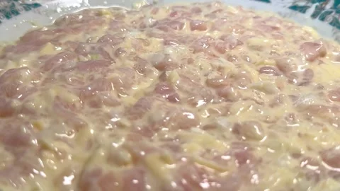 Raw diced chicken pieces mixed with creamy marinade on a plate Видео 341510467