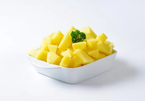 Raw diced potatoes in ceramic dish Stock Photos