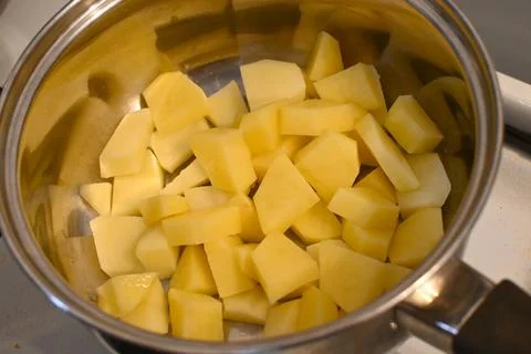Raw diced potatoes in a pot 스톡 사진