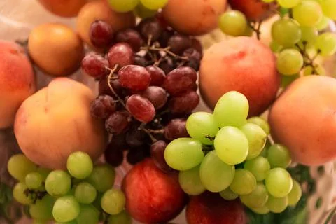 Raw different fruit on the plate, close up, top view Stock Photos