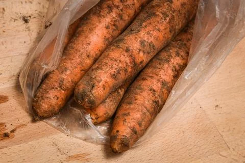 Raw dirty carrots on the table Fotos Stock