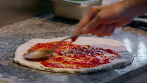 Raw dough and sauce. Process of making pizza. Stock Footage 159338925