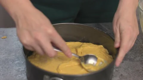 Raw dough in baking pan form spread liquid pastry with spoon ready bake pumpkin Stock Footage 219019077