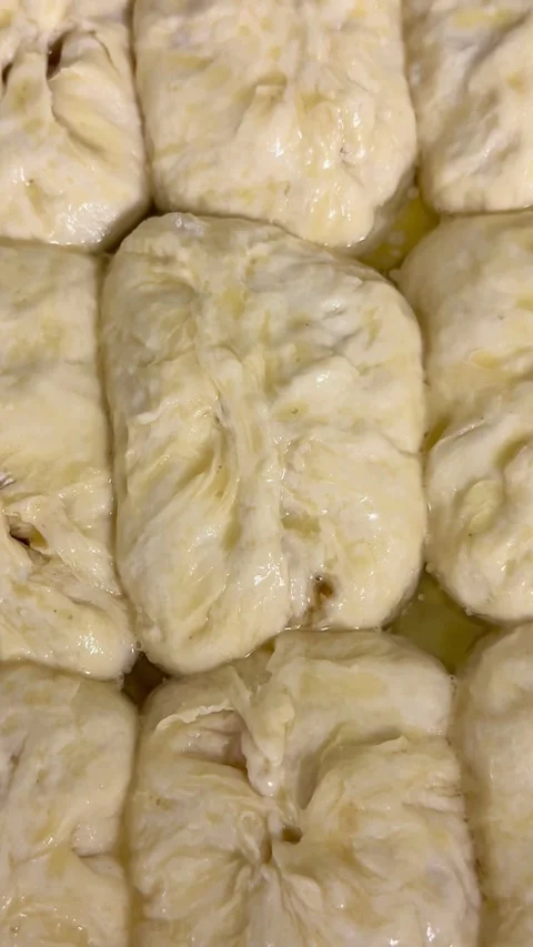 Raw dough buns in a tray ready for baking Video stock 331982880
