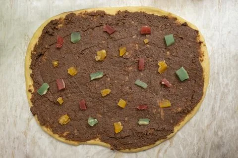 Raw dough with cocoa and multicolored turkish delight bits, cozonac making .. Stock Photos