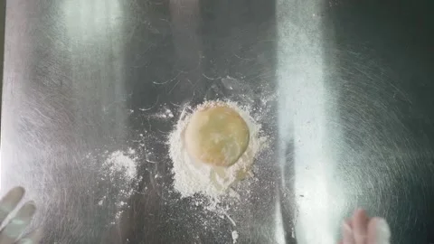 Raw dough falls onto an iron table Stock Footage 155203071