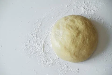 Raw dough lying on the table on a white background. A piece of dough for bread Stock Photos