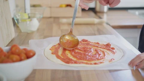 Raw dough for pizza preparation with ingredient: tomato sauce, mozzarella, to Stock Footage 128202162