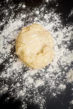 Raw dough is on the table with flour before cooking cottage cheese cookies Stock Photos