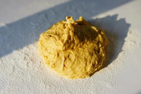 Raw dough on a table with sunlight. Easter or bakery concept 库存照片