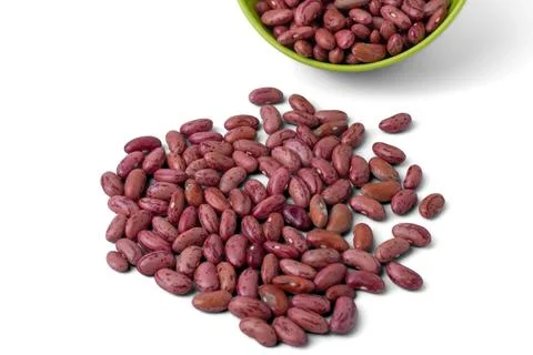 Raw dried red kidney beans spilled from a small bowl on a white background Stock Photos