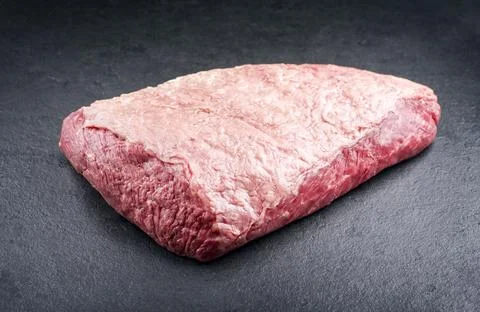 Raw dry aged wagyu cap of rump beef offered as close-up on black background w Foto stock