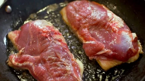 Raw duck breast is fried in a hot pan Video stock 333831071