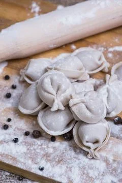 Raw dumpling on bamboo wickerwork with flour and pepper Stock Photos