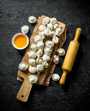 Raw dumpling with rolling pin and egg yolk. Stock-Fotos